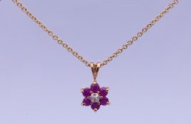 A 9 ct gold and ruby pendant on a 9 ct gold chain. Pendant 1.