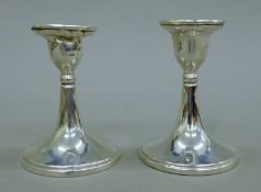 A pair of silver candlesticks. 10 cm high.