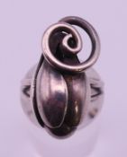 A Modernist unmarked silver ring formed as a tulip bud. Ring size J.