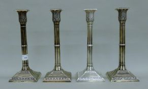 A set of four Victorian silver candlesticks of ribbed columnar form with cast acanthus leaf