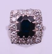 An unmarked white gold or platinum diamond and sapphire ring. Ring size M/N. 6.