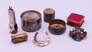 A silver napkin ring, a silver lid, a silver walking stick collar, a silver horseshoe brooch,