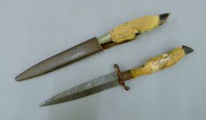 Two vintage German hoof-handled daggers, one in scabbard. The latter 30 cm long.