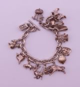 A silver charm bracelet with various charms. Bracelet 18 cm long. 55.3 grammes.