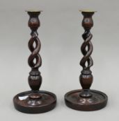 A pair of early 20th century oak barley twist candlesticks. Each 30 cm high.