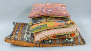 Four kilim-covered cushions, a cushion from Qala-e-Naw, Afghanistan and one other.