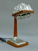 A leather and chrome desk lamp. 17 cm wide.