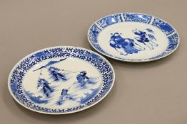 Two 18th century Chinese porcelain plates, one decorated with waring figures. Each 21.5 cm diameter.