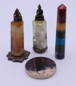 Mineral specimens to include two columnar pillars with metal Buddha figures.
