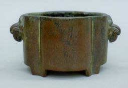 A Chinese bronze censer, the handles formed as birds. 15 cm wide.