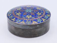 An unmarked silver and enamel pill box. 4.5 cm diameter.