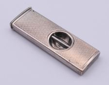 A silver cigar cutter. 5 cm long.