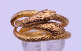 A gilt metal double snake ring. Ring size M.