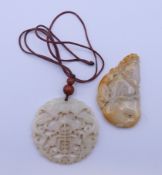 Two Chinese carved jade pendants. 6 cm diameter and 7 x 4 cm.
