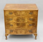 An early 20th century walnut bow front chest of drawers. 76 cm wide.