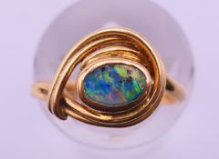 An 18 ct gold and black opal ring. Ring size J. 3 grammes total weight.