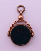 A 9 ct gold bloodstone and carnelian swivel fob. 3.5 cm high.8.1 grammes total weight.