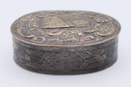 An 800 silver snuff box, the lid embossed with a scene of an amphitheatre, possibly the Colosseum.