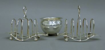 Two silver plated toast racks and a silver plated cauldron form vase. The latter 6 cm high.