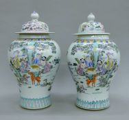 A pair of Chinese porcelain lidded vases. Each 40 cm high.