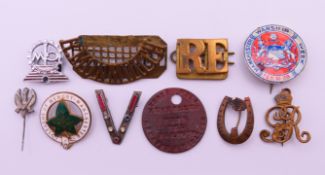 A small collection of military badges. The largest 5 cm wide.