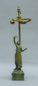 An Art Nouveau-style table lamp surmounted with a young girl. 46 cm high.