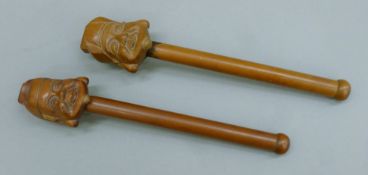 Two Japanese handled wooden boxes, each formed as a face. Each 26.5 cm long.