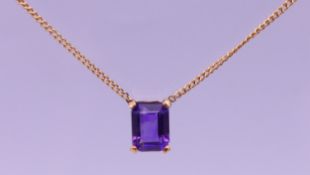 A 9 ct gold amethyst pendant necklace. Amethyst pendant 1 cm high, chain 39 cm long. 2.