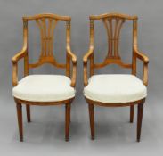 A pair of Empire-style upholstered open armchairs. Each 51 cm wide.