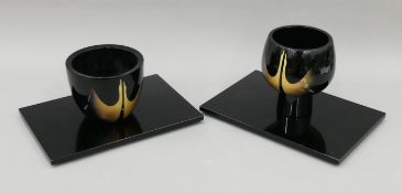 Two Japanese lacquered vases on stands. The larger 18.5 cm high.