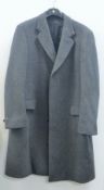 A gentlemen's 3/4 length Crombie grey wool overcoat. Approximate chest measurement 118 cm.