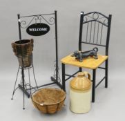 A chair, a boot scraper formed as a dachshund, a hanging basket stand,