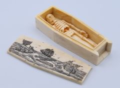 A carved bone model of a coffin and skeleton. 11.5 cm long.