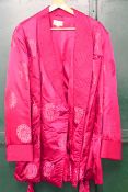 A Chinese padded silk gentlemen's smoking jacket with fringe tie belt.