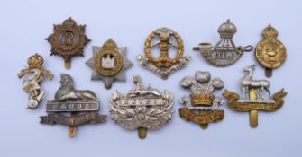 Ten World War I and World War II cap badges. Lincolnshire badge 5.5 cm wide.