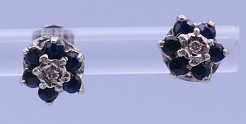 A pair of 9 ct gold, diamond and sapphire flowerhead ear studs. 6 mm diameter.
