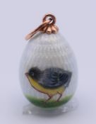 A 14 ct gold enamel chick egg pendant, bearing Russian marks. 2 cm high excluding suspension loop.