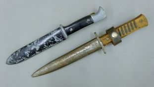 Two World War II German military knives: a boot dagger and another. The larger 28 cm long.