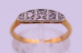 An 18 ct gold and platinum five-stone diamond ring. Ring size M. 2.4 grammes total weight.