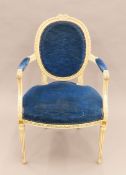 An early 20th century blue-upholstered white-painted open armchair. 60 cm wide.