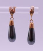 A pair of unmarked gold and hematite ear drops, one with 9ct back the other with a 14 ct back. 2.