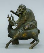 A bronze of Shou Lao (Shoulao) riding a deer. 13.5 cm high.