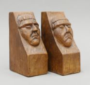 A pair of oak bookends carved with monks. Each 16 cm high.