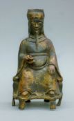 A Chinese bronze of a seated official. 23 cm high.