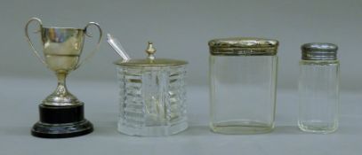 Two silver lidded glass jars, a silver lidded glass preserve pot and spoon,