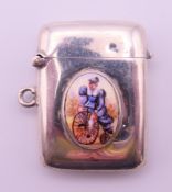 A silver vesta with roundel depicting a lady riding a penny farthing bicycle. 4 cm high.