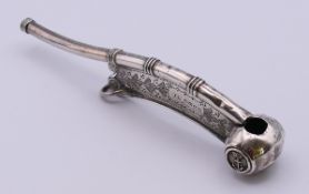 A Royal Navy silver Bosun's whistle of typical form with foliate engravings,
