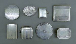 A collection of small silver items, including vestas, compacts,