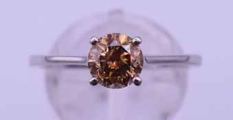 A platinum and brown diamond solitaire ring, the stone spreading to approximately 0.75 ct.