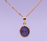 A 14 K gold and opal pendant on a 9 ct gold chain. Pendant 2 cm high, chain 45 cm long. 2.